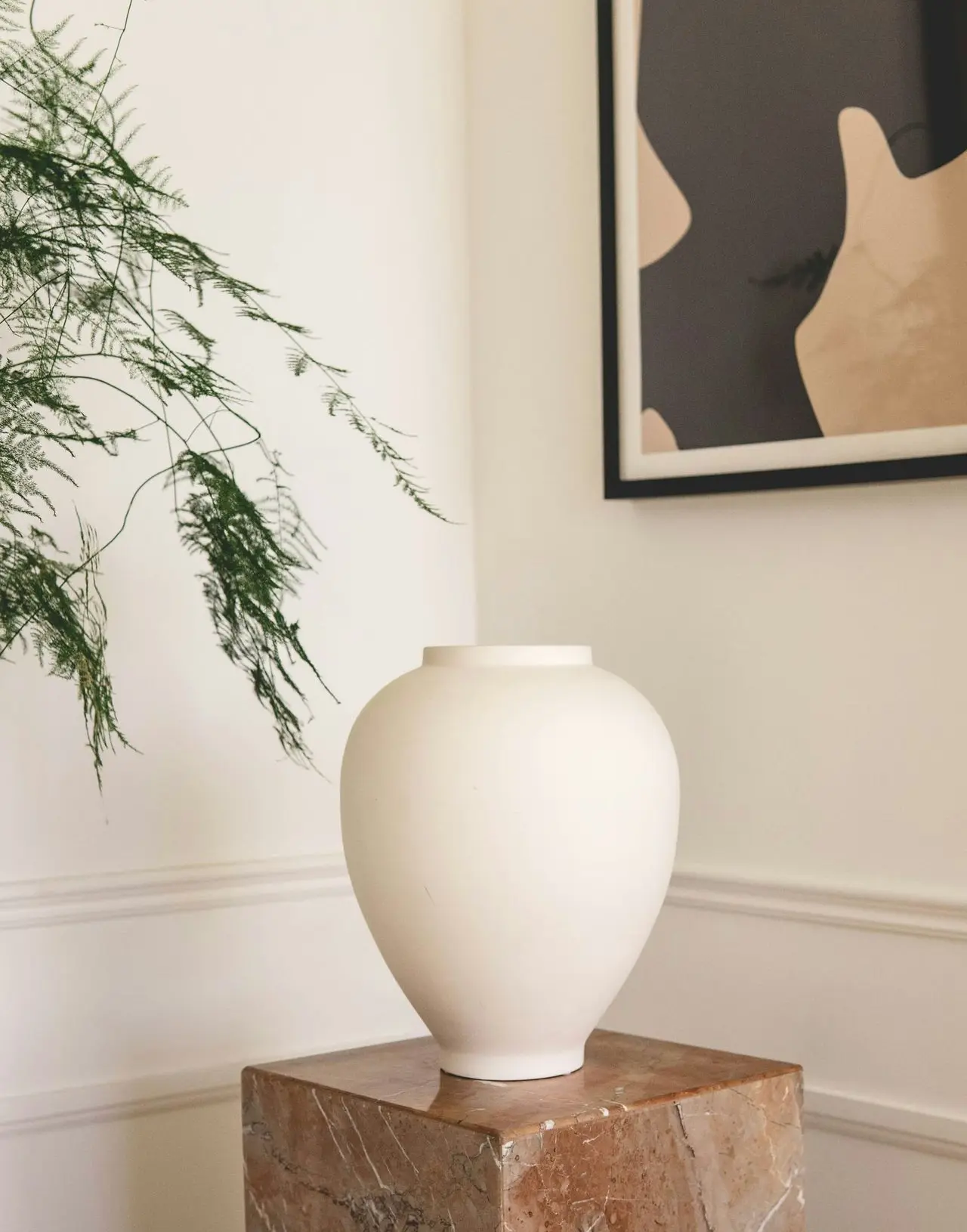 white ceramic vase on brown wooden table